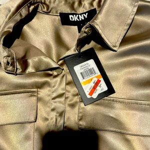 DKNY shirt in goldish color. NWT never worn size small. Loose fitting